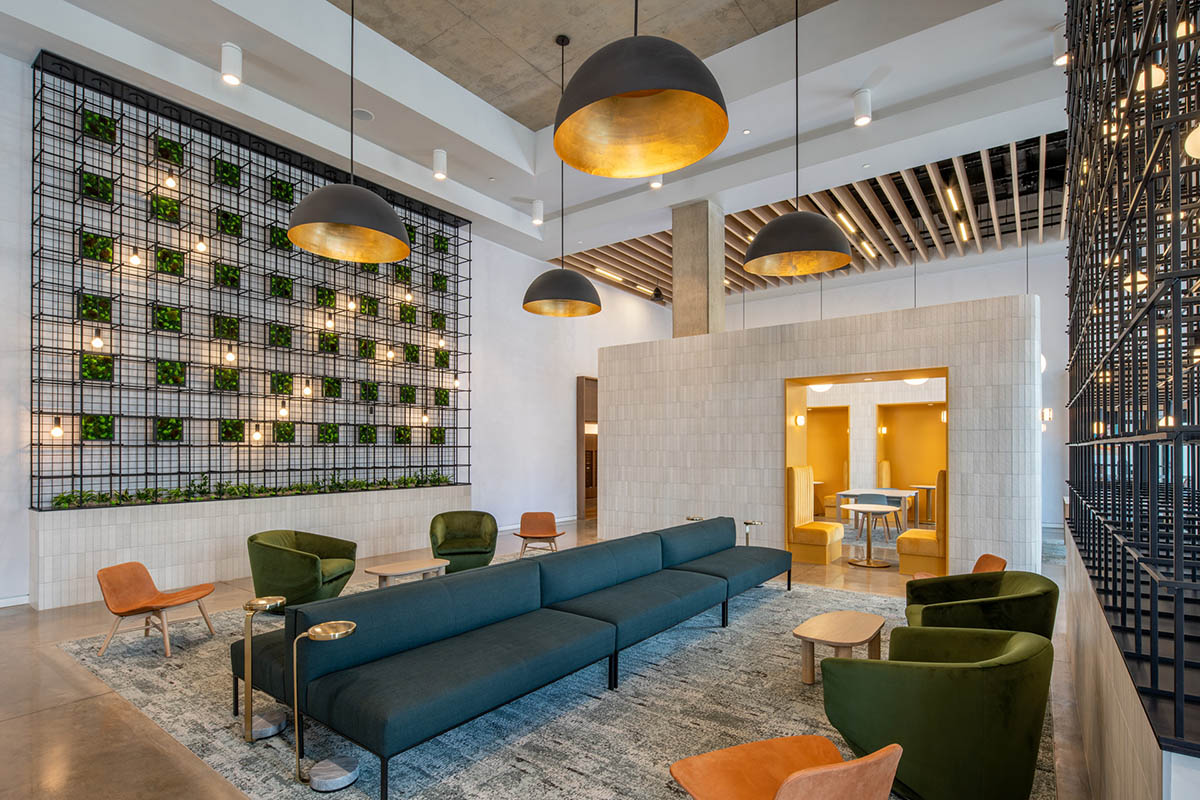 Lounge with vaulted ceilings, comfortable seating, and eclectic decor.